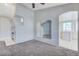 Inviting living room with a cozy fireplace, mirrors, neutral carpet, and access to the kitchen at 4724 Victoria Beach Way, Las Vegas, NV 89130