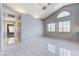 Bright living room featuring tile flooring, large windows, high ceilings, and a ceiling fan at 4724 Victoria Beach Way, Las Vegas, NV 89130