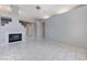 Bright living room featuring tile flooring, a fireplace, and open access to other spaces at 4724 Victoria Beach Way, Las Vegas, NV 89130