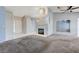 Open-concept living area with a cozy fireplace, tile entry, and bright natural light at 4724 Victoria Beach Way, Las Vegas, NV 89130