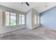 Bright living room with neutral carpet, backyard view and ceiling fan at 4724 Victoria Beach Way, Las Vegas, NV 89130