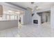 Open living space with tile floors, a fireplace, and views into the kitchen at 4724 Victoria Beach Way, Las Vegas, NV 89130