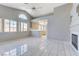 Bright living room with tile flooring, vaulted ceiling, fireplace, and kitchen access at 4724 Victoria Beach Way, Las Vegas, NV 89130