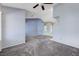 Spacious living area featuring plush carpet, high ceilings, and entry to the laundry area at 4724 Victoria Beach Way, Las Vegas, NV 89130