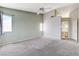 Spacious main bedroom with carpet flooring, ceiling fan, and ensuite bathroom provides a peaceful retreat at 4724 Victoria Beach Way, Las Vegas, NV 89130