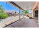 Covered back patio with gravel landscaping, mature plants, and a concrete pad at 4724 Victoria Beach Way, Las Vegas, NV 89130