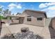 Backyard with firepit, covered patio, and block wall for privacy creates an outdoor oasis at 5001 Morning Falls Ave, Las Vegas, NV 89131