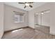 Bright bedroom featuring wood-look flooring, a window, ceiling fan, and mirrored closet at 5001 Morning Falls Ave, Las Vegas, NV 89131