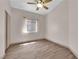 Bedroom with wood flooring, ceiling fan, and large window with natural light at 5001 Morning Falls Ave, Las Vegas, NV 89131