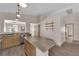 Open kitchen with granite countertops, stainless steel appliances, wood cabinets, and an island looking to the living space at 5001 Morning Falls Ave, Las Vegas, NV 89131