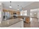 Well-lit kitchen featuring stainless steel appliances, a center island, and wood-style flooring, providing ample counter space at 5001 Morning Falls Ave, Las Vegas, NV 89131