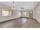Open living room featuring wood flooring, natural light, and modern chandelier at 5001 Morning Falls Ave, Las Vegas, NV 89131