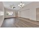 Bright living room with wood flooring, ceiling fan, and chandelier lighting at 5001 Morning Falls Ave, Las Vegas, NV 89131