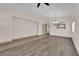 Spacious living room with wood flooring, ceiling fan and bright natural light at 5001 Morning Falls Ave, Las Vegas, NV 89131
