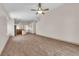 Spacious living room with wood-look flooring and an open layout, offering a seamless flow into other areas of the home at 5001 Morning Falls Ave, Las Vegas, NV 89131