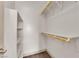 Organized walk-in closet with built-in shelves and hanging rods at 5001 Morning Falls Ave, Las Vegas, NV 89131
