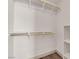 Organized walk-in closet with built-in shelves and hanging rods at 5001 Morning Falls Ave, Las Vegas, NV 89131