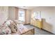 Bright bedroom featuring a rattan daybed, pastel pink drapes, and a large dresser at 514 Red Lovebird Ave # Lot 1241, Henderson, NV 89011