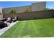 Spacious backyard featuring artificial turf and cozy seating, perfect for outdoor relaxation and entertainment at 5414 Enchanted Rose St, Las Vegas, NV 89148