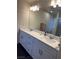 Bathroom featuring a double-sink vanity, large mirror, and vanity lights at 5414 Enchanted Rose St, Las Vegas, NV 89148