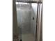 Bathroom with a glass door shower featuring faux marble tiling, a sleek handle, and modern fixtures at 5414 Enchanted Rose St, Las Vegas, NV 89148