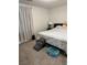 Neutral bedroom features a bed, side table, dark nightstand, and pet accessories at 5414 Enchanted Rose St, Las Vegas, NV 89148