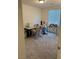 Cozy craft room with a sewing machine, rocking chair, and abundant natural light from the window at 5414 Enchanted Rose St, Las Vegas, NV 89148