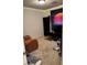 This bedroom features an orange couch, storage shelves, and vibrant wall art, creating a relaxed atmosphere at 5414 Enchanted Rose St, Las Vegas, NV 89148