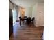 Well-lit dining area features a dark table, four chairs, and wood-look flooring at 5414 Enchanted Rose St, Las Vegas, NV 89148