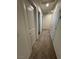 Hallway with carpeted flooring and multiple paneled doors at 5414 Enchanted Rose St, Las Vegas, NV 89148