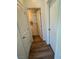 Hallway view with wood-look flooring leading to a door opening into a bathroom at 5414 Enchanted Rose St, Las Vegas, NV 89148