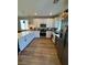 Modern kitchen with white cabinets, stainless steel appliances, and wood flooring at 5414 Enchanted Rose St, Las Vegas, NV 89148