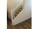 Staircase with white banisters and gray treads, complemented by sleek horizontal railings and wood-look flooring at 5414 Enchanted Rose St, Las Vegas, NV 89148