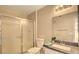Bathroom with sliding glass shower doors and a modern single sink vanity at 5710 E Tropicana Ave # 2225, Las Vegas, NV 89122