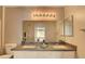 Bathroom featuring double sinks, white cabinets, and a large mirror at 5710 E Tropicana Ave # 2225, Las Vegas, NV 89122
