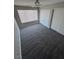 This bright bedroom has gray carpet, a ceiling fan, and a window with light-blocking blinds at 5710 E Tropicana Ave # 2225, Las Vegas, NV 89122