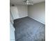 This airy bedroom features gray carpet, white trim, a ceiling fan, and freshly painted walls at 5710 E Tropicana Ave # 2225, Las Vegas, NV 89122