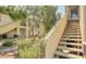 Charming condo exterior featuring well-maintained landscaping and inviting staircase at 5710 E Tropicana Ave # 2225, Las Vegas, NV 89122