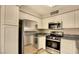 Bright kitchen featuring stainless steel appliances, ample cabinetry, and modern countertops at 5710 E Tropicana Ave # 2225, Las Vegas, NV 89122