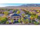 An elevated view of a home with solar panels, a pool, a spa and mountain views at 5805 Cabo San Lucas Ave, Las Vegas, NV 89131