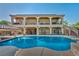 Expansive backyard featuring pool, covered patio, lush landscaping, and two-story house at 5805 Cabo San Lucas Ave, Las Vegas, NV 89131