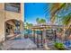 Expansive backyard with a covered patio, outdoor kitchen, and a view of the lush landscaping at 5805 Cabo San Lucas Ave, Las Vegas, NV 89131