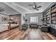 Spacious bedroom featuring a decorative brick wall, bookshelves, and hardwood floors at 5805 Cabo San Lucas Ave, Las Vegas, NV 89131