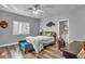 Bedroom showcasing a bed, window with shutters, and wood floors at 5805 Cabo San Lucas Ave, Las Vegas, NV 89131