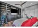 Bedroom featuring exercise equipment, built-in shelves and cabinets, plus wood flooring at 5805 Cabo San Lucas Ave, Las Vegas, NV 89131