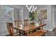 Well-lit dining area with natural light from shuttered windows and a wooden dining set at 5805 Cabo San Lucas Ave, Las Vegas, NV 89131