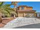 Charming two-story home with a tile roof, an attached two-car garage, and a well-manicured lawn at 5805 Cabo San Lucas Ave, Las Vegas, NV 89131