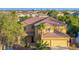 Beautiful two-story home featuring a red tile roof, attached two-car garage, and lush landscaping at 5805 Cabo San Lucas Ave, Las Vegas, NV 89131