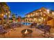 Stunning backyard with sparkling pool, fire pit, outdoor seating, and two-story home at 5805 Cabo San Lucas Ave, Las Vegas, NV 89131