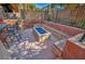 Outdoor fire pit with built-in seating and blue glass, perfect for entertaining in a modern backyard at 5805 Cabo San Lucas Ave, Las Vegas, NV 89131